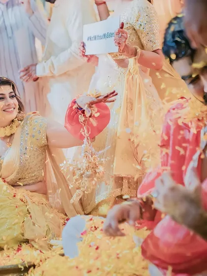 The bride's side making sure the groom gets his fair share of flowers and fun during the Haldi.