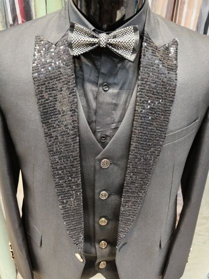 A collection of our designer suits, showcasing a variety of colors, fabrics, and custom details like embroidery, unique lapels, and accessories. Each piece is crafted to make a lasting impression.