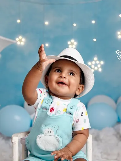 Reaching for the stars, one dream at a time. A happy baby looks up with wonder in our magical moon and stars setup.