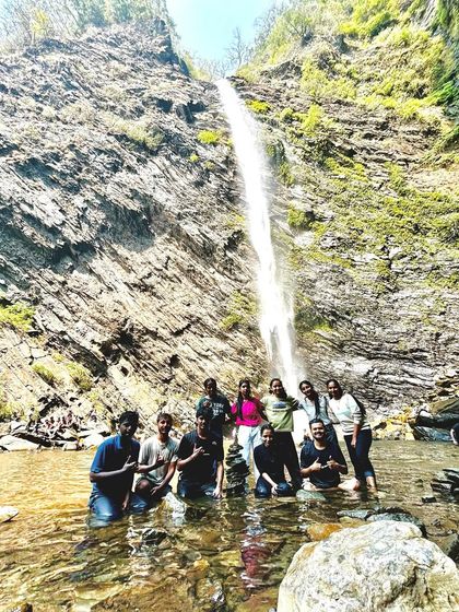 Our group posing in the water at Koodlu Theertha falls, a memorable moment from our coastal adventure.