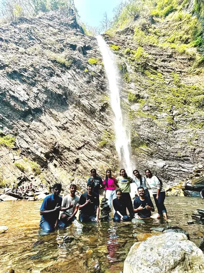 Our group posing in the water at Koodlu Theertha falls, a memorable moment from our coastal adventure.