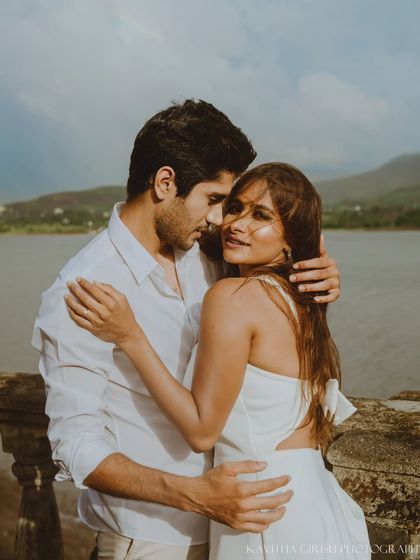 A beautiful close-up portrait where the woman connects with the camera while being held by her partner. This style of shot is both intimate and engaging.