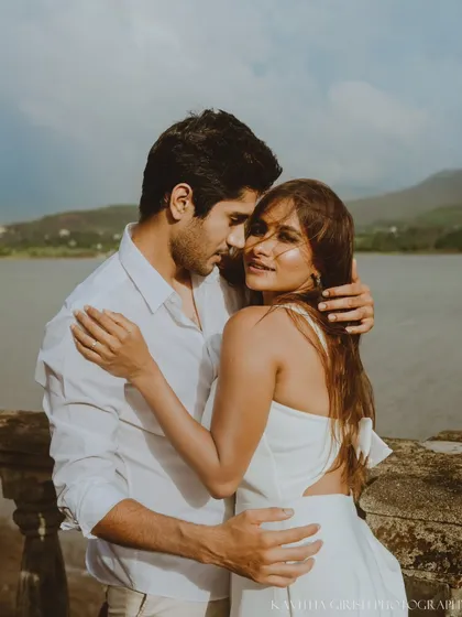 A beautiful close-up portrait where the woman connects with the camera while being held by her partner. This style of shot is both intimate and engaging.