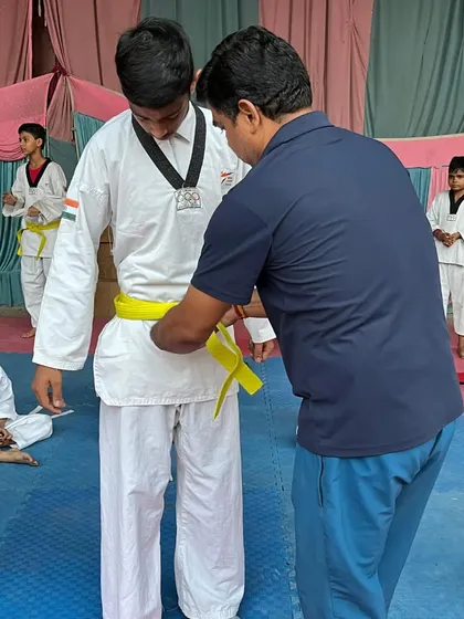 Another student receives his yellow belt. I take pride in guiding each student personally through their progression.