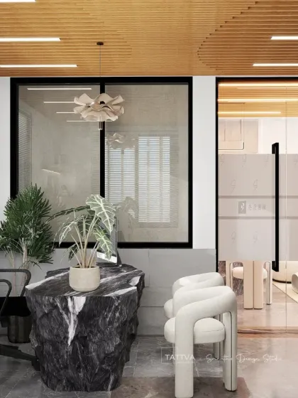 Another view of the modern office interior, this time focusing on a principal's cabin with a statement raw stone desk and minimalist decor.