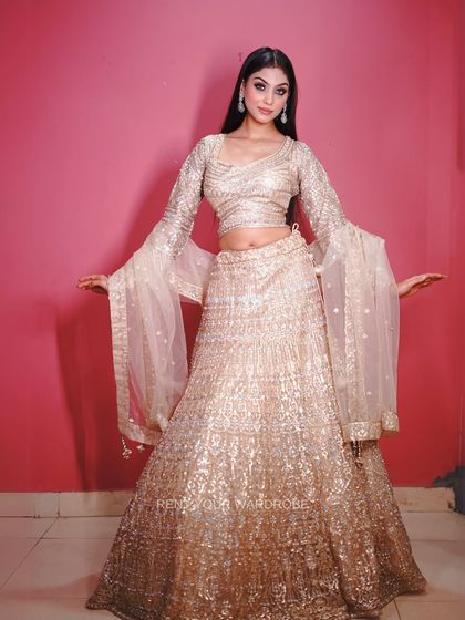 This golden sequin lehenga is all about glamour. The bell sleeves add a trendy, retro touch perfect for a sangeet or cocktail party look.