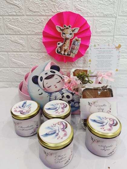 You can see the contents of the pram hamper here, including four beautifully decorated treat jars.