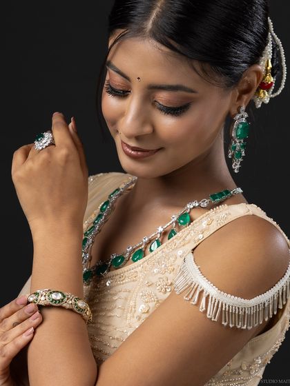 A portrait of the model admiring her emerald bangle, a great shot for a jewellery brand.