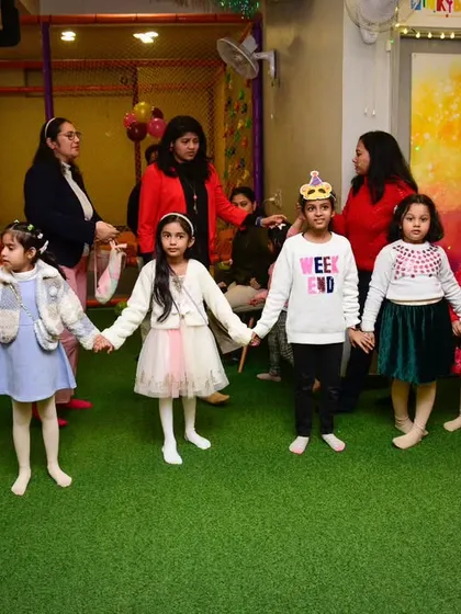 Holding hands and playing a circle game. It's beautiful to see the kids connecting and having fun together.