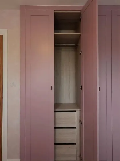 Another interior view, highlighting the combination of hanging space and deep drawers for versatile storage.
