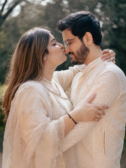 A sweet kiss on the nose, a simple gesture of affection captured in a beautiful, naturally lit outdoor setting.