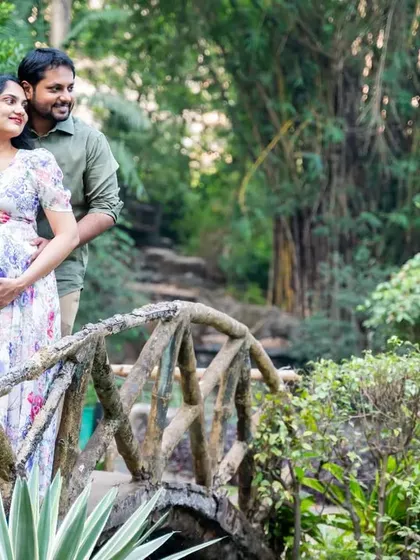 Looking towards the future together. This couple shares a moment on a rustic bridge, surrounded by the peacefulness of nature.