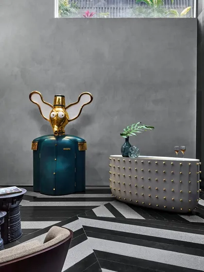 The bar area at the Baid Residence, featuring a whimsical elephant-shaped bar from Scarlet Splendour. The chevron black and white flooring adds a bold, graphic contrast to the playful furniture.