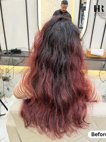 The "before" shot for a color correction and highlight service. The hair has grown-out red tones that need to be blended.