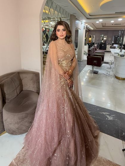 A full view of this elegant engagement gown. The soft, flowing curls and glamorous makeup complete this picture-perfect look.