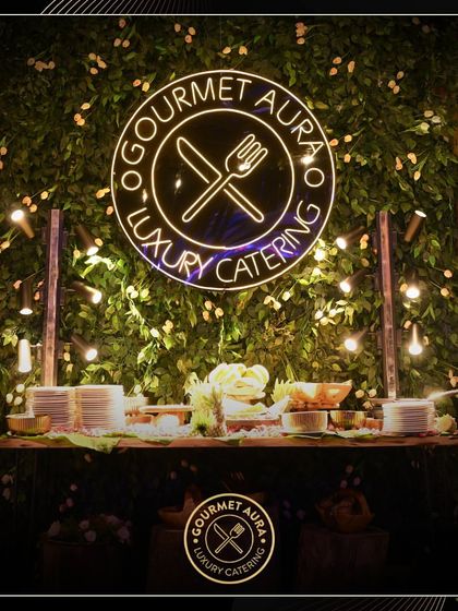 Our branded buffet station at the Gourmet Fest, featuring a lush green wall and our neon logo. We create a strong and stylish brand presence at every event.