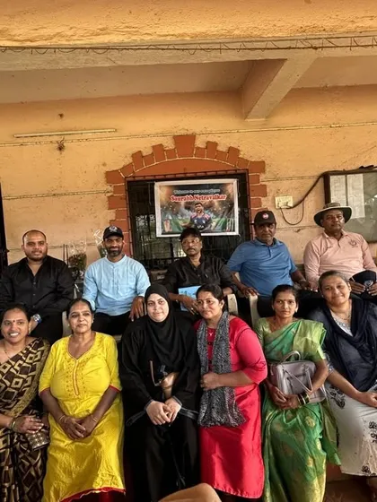 The parents of our young cricketers pose for a photo with Saurabh Netravalkar and our coaching staff, showing the collaborative spirit of our academy.