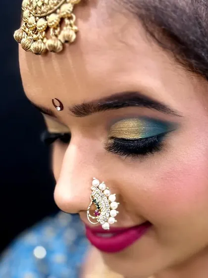 The eyes tell a story, especially in bridal makeup. This close-up on a Maharashtrian bride shows a beautiful blend of gold and teal eyeshadow with a sharp wing, a technique I cover in detail in my Indian bridal workshops.