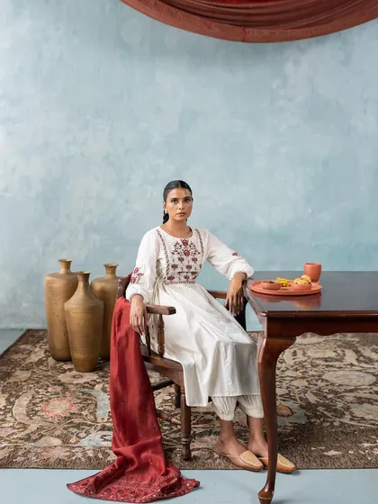 This look for the 'Folksong' campaign features an elegant white embroidered kurta set. The styling is minimal and clean to let the craftsmanship of the garment shine.