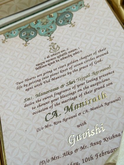 A look inside a luxury hamper box. The invitation itself is exquisitely detailed with gold foil text and traditional patterns, setting the tone for a grand celebration.