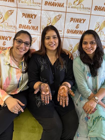 A happy client with me and my sister Bhavna, showcasing her beautiful Karwa Chauth mehndi. Her smile is the best reward for our art.