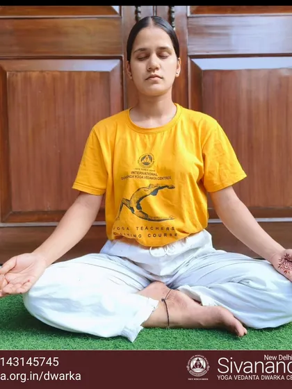 A student sits in Sukhasana (Easy Pose) for meditation. Daily meditation is a key practice for achieving emotional balance and inner peace.