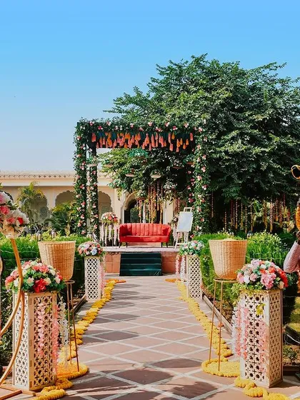 The entrance to a royal mehendi ceremony. The beautiful decor, floral arrangements, and traditional musician set the stage for a grand celebration.