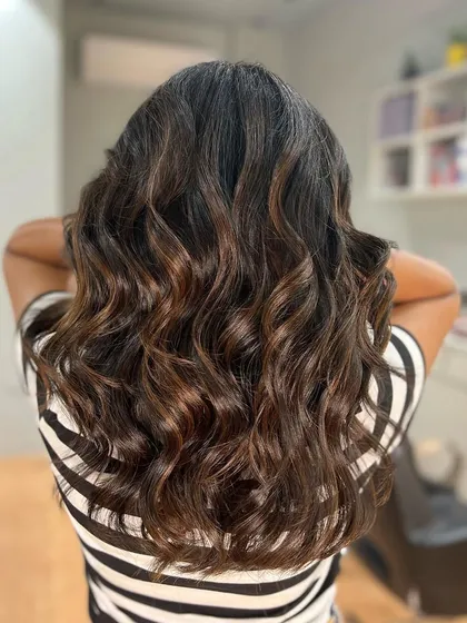 Another look at a chocolate brown balayage, showing how the light catches the different tones. This color is incredibly versatile and looks great on many skin tones.