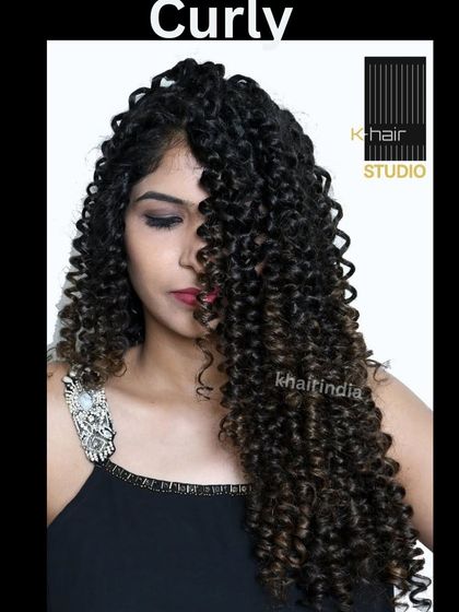 For all the curly-haired girls, we have you covered. This image shows a half-wig with beautiful, defined curls, perfect for adding volume and length to your natural hair.