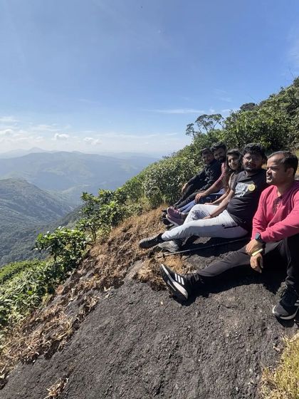 Resting on the edge of the trail, our group takes in the stunning valley views that Kumara Parvatha offers.