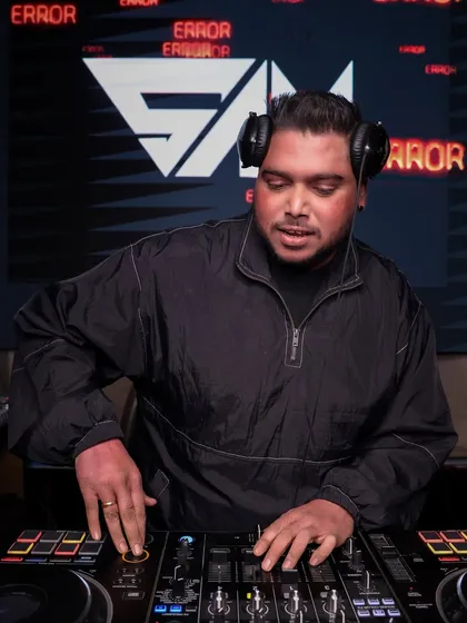 Focused on the mix, using my professional Pioneer DJ setup to blend tracks seamlessly. I’m an open-format DJ, ready to drop everything from Bollywood bangers to old-school Hip Hop to keep the vibe just right.