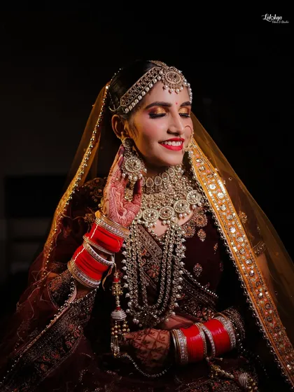 That priceless smile of a happy bride. This candid shot captures the bride's joy on her wedding day, with beautiful lighting that accentuates her smile and the sparkle of her jewelry.