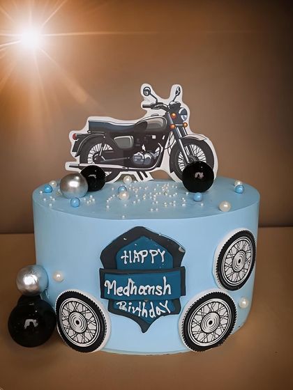 A non-fondant Bullet theme cake for a motorcycle enthusiast. The design features a bike topper, wheels, and a custom nameplate.