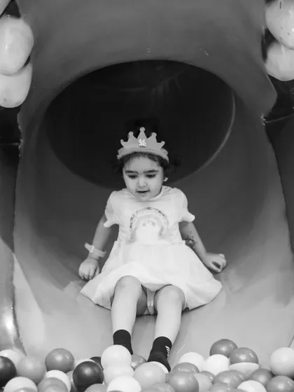 A quiet moment on the slide. Even in black and white, the joy of play shines through.