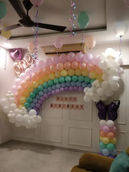 A full view of the pastel rainbow decoration, showing how it transforms a living room wall.