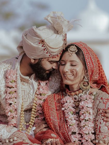 A close, intimate portrait of the couple, their foreheads touching, lost in a moment of love and connection.