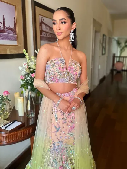 The full look, showcasing the beautiful pastel floral lehenga and the modern, chic makeup that complements it perfectly.