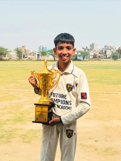 A happy winner with the Summer Cricket Cup trophy. These are the moments that inspire us.
