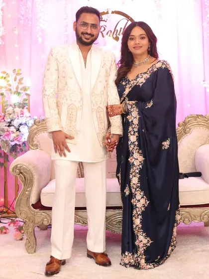 The lovely couple on their engagement day. The saree's pallu is neatly pleated and secured, so she can celebrate without a worry.