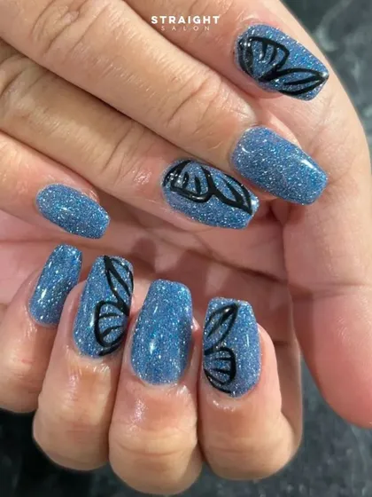 A close-up of the hand-painted butterfly wings. The contrast between the black outline and the sparkling blue base is stunning.