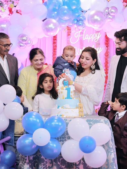 The whole family gathers to help Vedang with his first birthday cake. Capturing multi-generational moments like this is one of the great joys of family event photography.