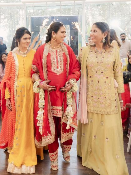 Walking in with the two most important women in her life. The Godh Bharai entry is a beautiful tradition that I love to make extra special for my clients.