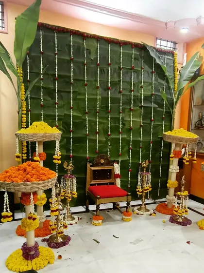 I create authentic and intimate setups for home-based pujas and baby showers. This decor uses a traditional banana leaf backdrop, fresh marigold garlands, and a decorated chair for the mom-to-be, bringing timeless traditions to your space.