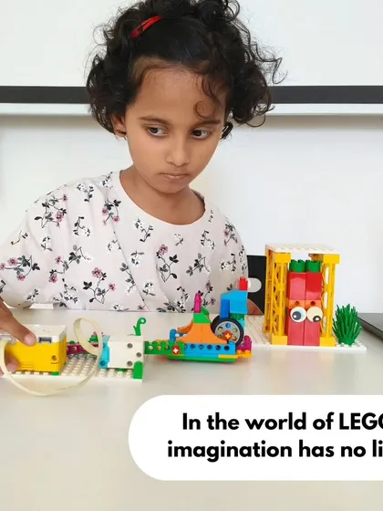Our programs are designed to be accessible and engaging for young learners. This young innovator is completely absorbed in her LEGO project, showing that imagination and learning can start at any age.