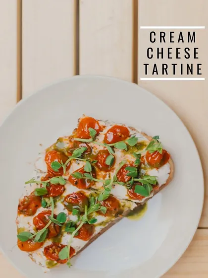 Our Cream Cheese Tartine, topped with roasted cherry tomatoes and fresh microgreens. The coriander pesto underneath adds a secret layer of flavor.