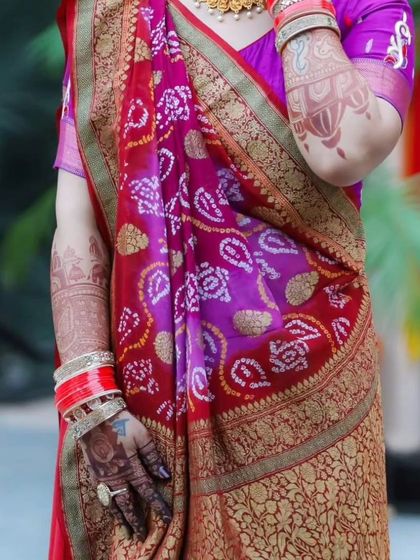 A full-length shot showing how the beautiful arm mehendi complements the bride's entire look.