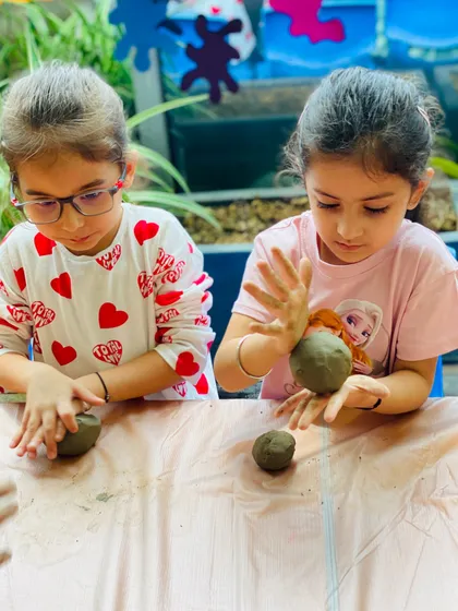 Side-by-side, these two are learning the fundamentals of sculpting with clay. It's a great activity for friends to do together, sharing tips and ideas as they go.