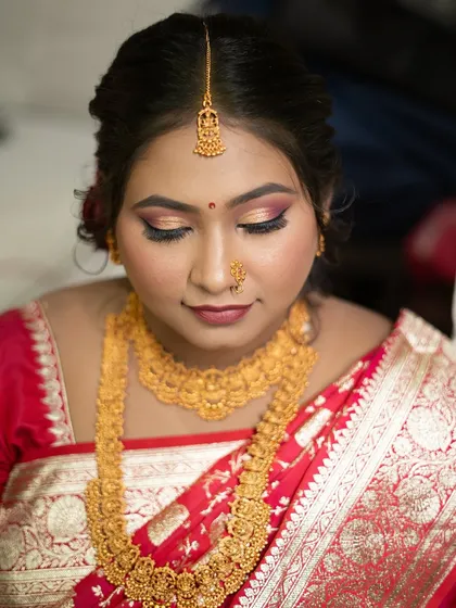 A detailed shot of the eye makeup and jewelry for a traditional bridal look, perfect for a November wedding.