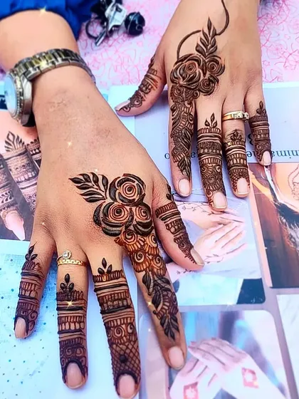 A focus on finger details, with intricate bands and a single rose motif.