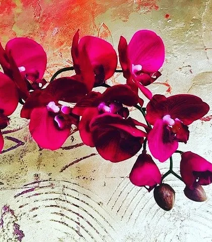 A close-up view of a hand-painted floral mural on a textured, metallic-finish background. This image highlights our ability to combine artistic painting with specialized texture techniques for a truly custom wall finish.
